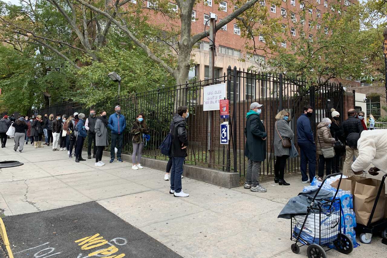 People queue outside an early voting station in Manhattan a week before the US presidential election.