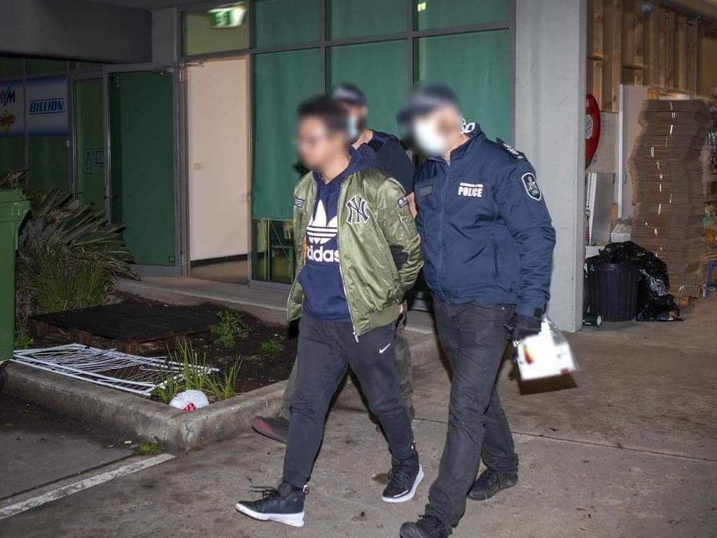 Three men were arrested after a raid on an alleged international money-laundering syndicate.