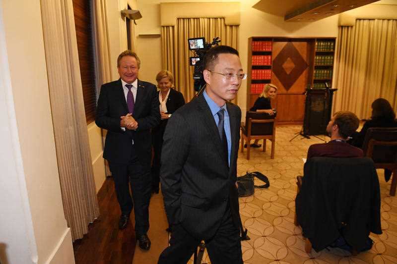 Long Zhou (centre) departs a press conference at the Commonwealth Parliamentary Offices in Melbourne, Wednesday, April 29, 2020