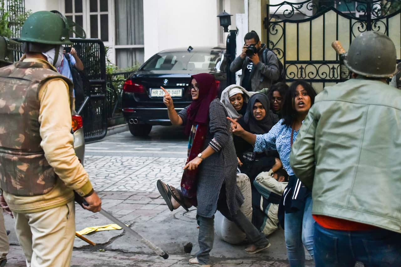 Ayesha Renna (C) and other protesters argue with policemen during a demonstration against the Indian government's Citizenship Amendment Bill (CAB) in New Delhi.