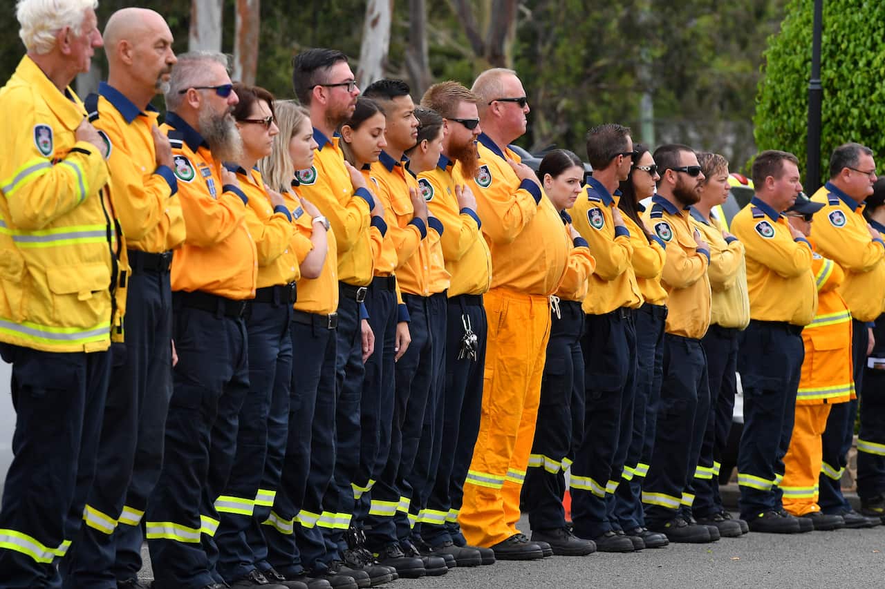 NSW RFS volunteers make an honour guard for Andrew O'Dwyer, a firefighter who died while battling a blaze in December. 