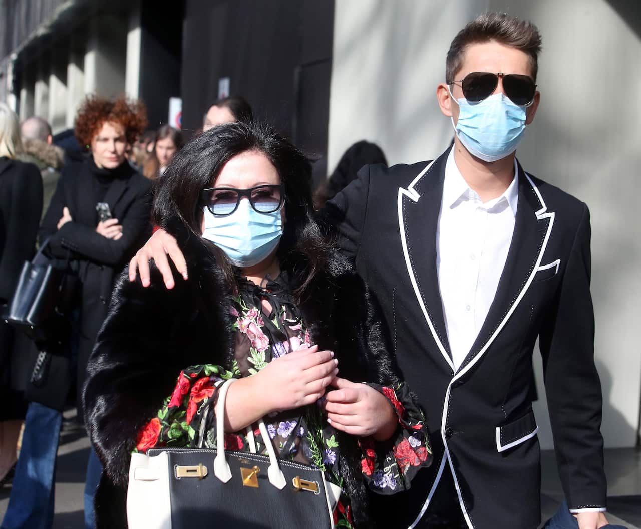 Guests attending the Dolce and Gabbana show at Milan Fashion Week arrive in face masks. 