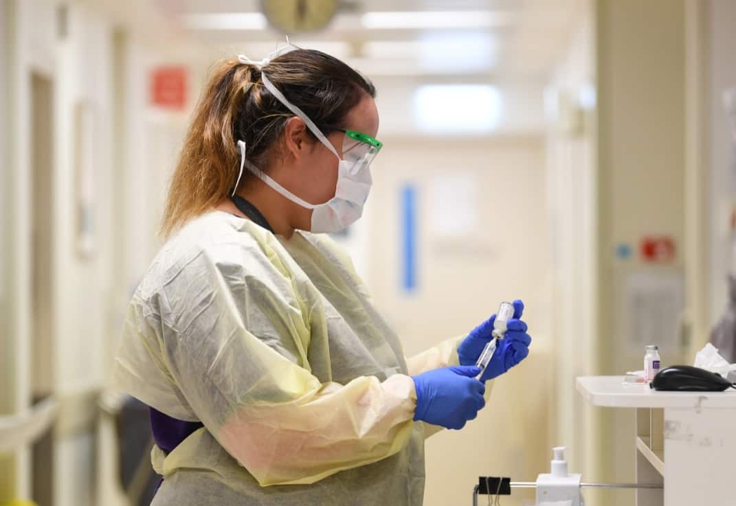 A healthcare worker conducts coronavirus screening inside a Melbourne hospital. 