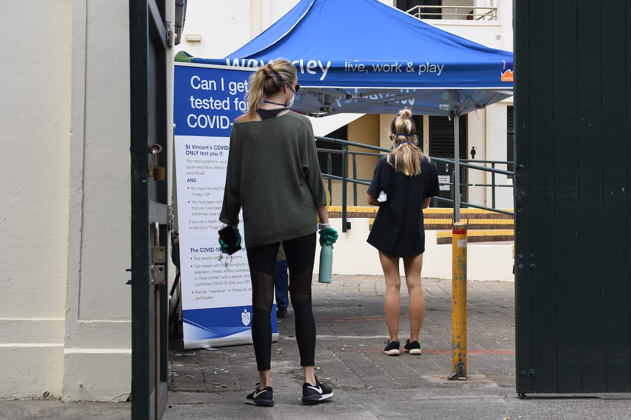 Nursing staff from St. Vincents Hospital see local residents and backpackers at a COVID-19 testing clinic in the Bondi Pavillion on Bondi Beach.