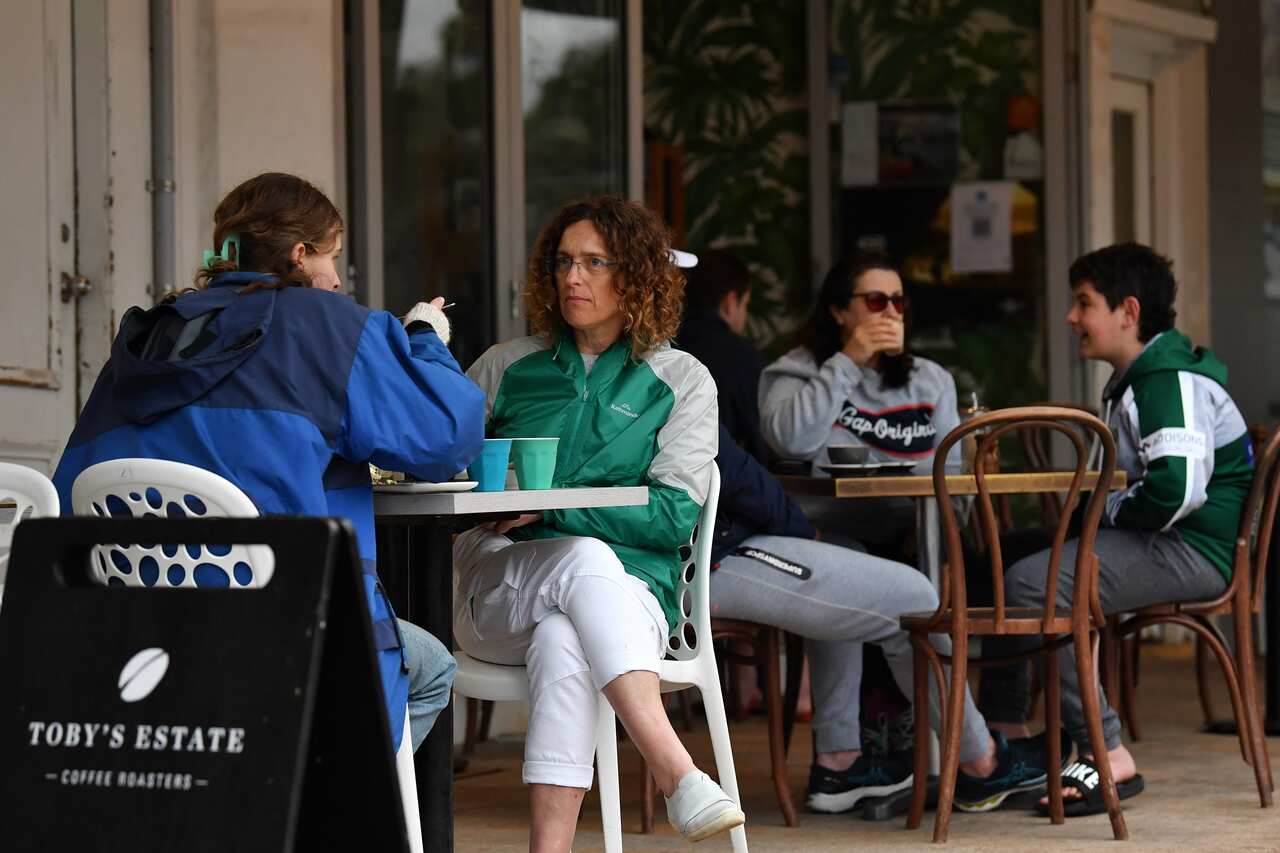 Diners sit a a cafe following 108 days of lockdown at Bronte in Sydney, Monday, October 11, 2021. 