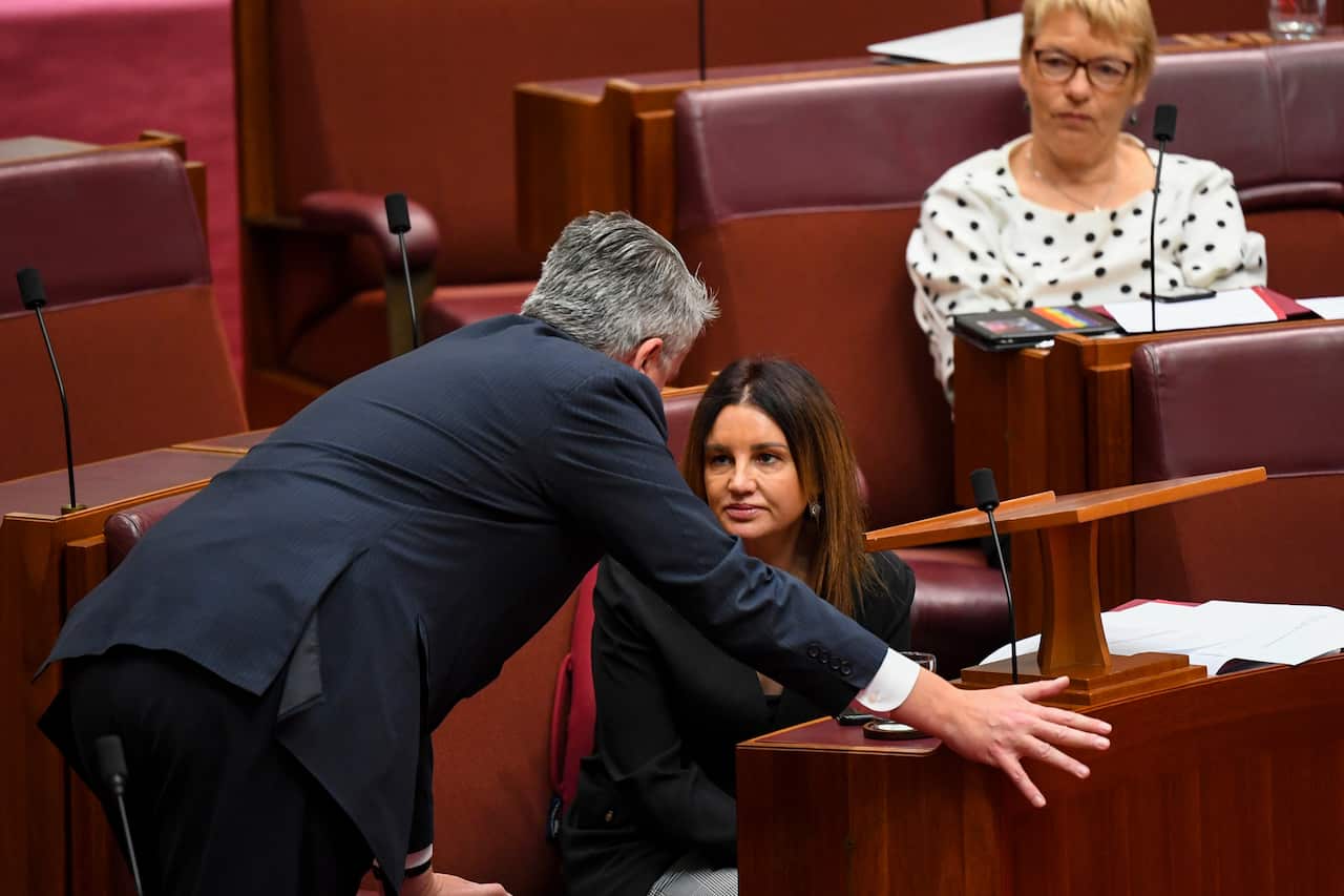 Crossbench Senator Jacqui Lambie (right) speaks with the Leader of the Government in the Senate Mathias Cormann.