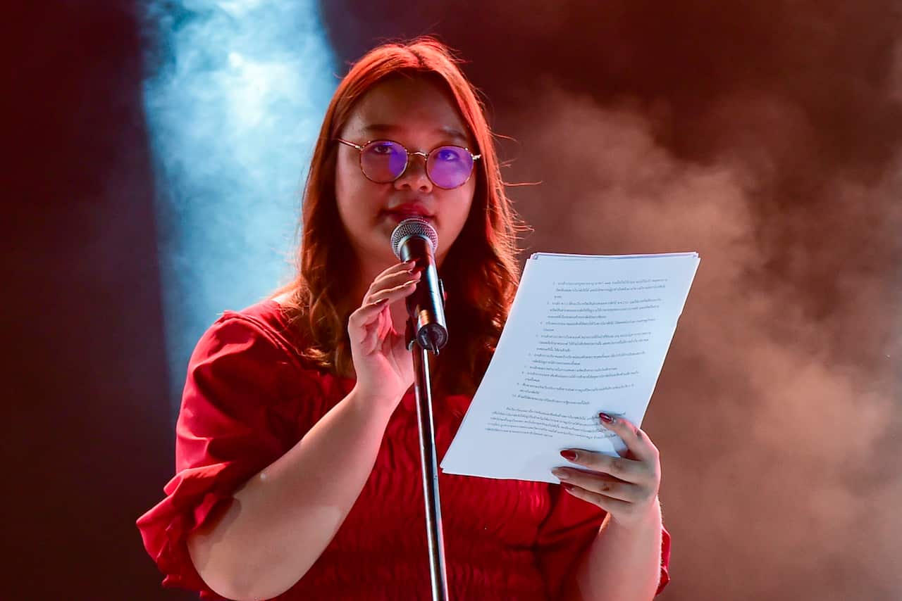 Student Union of Thailand spokesperson Panusaya Sithijirawattanakul reads the list of demands to reform the monarchy.