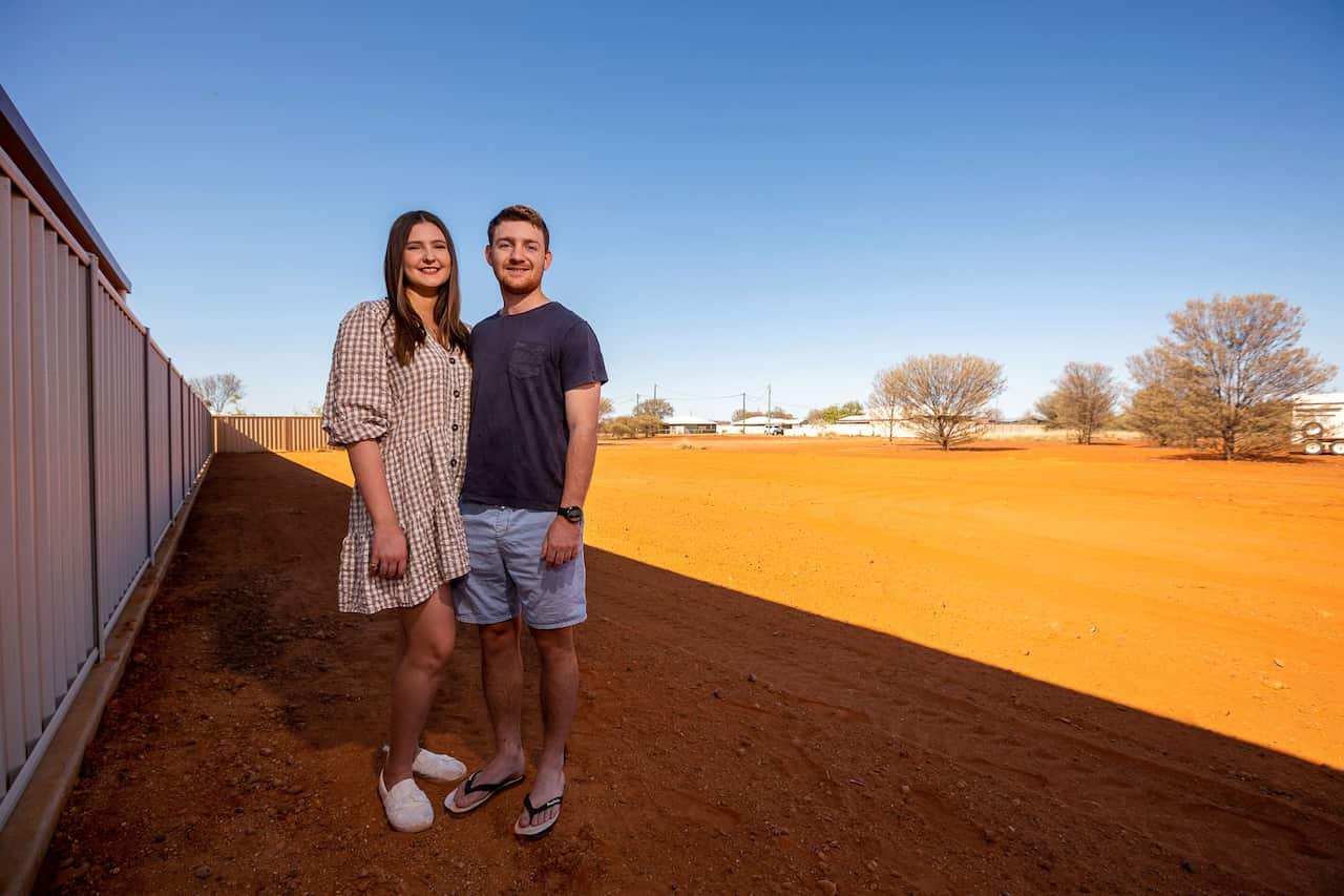 Tom Hennessy, right, and his fiancee Tessa McDougall stand on their land in the Australian Outback town of Quilpie, on Oct. 2, 2021