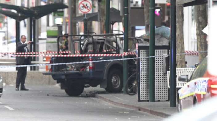 A burnt out vehicle is seen on Bourke Street in Melbourne