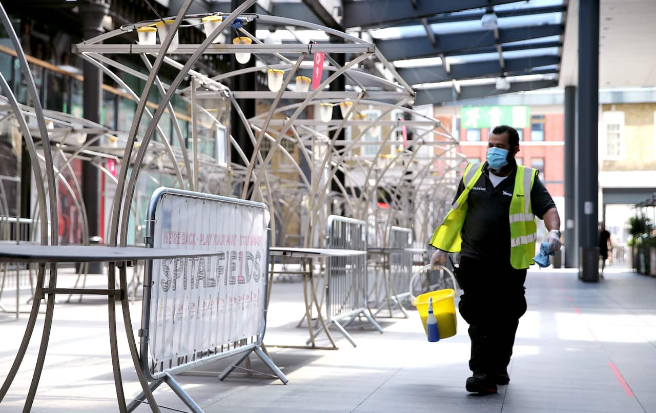 A cleaner walks through Spitalfields Market in East London, as the market has rearranged its stalls layout to respect social distance guidelines, as the government begins easing some lockdown measures in England. Picture date: Monday June 1, 2020..
