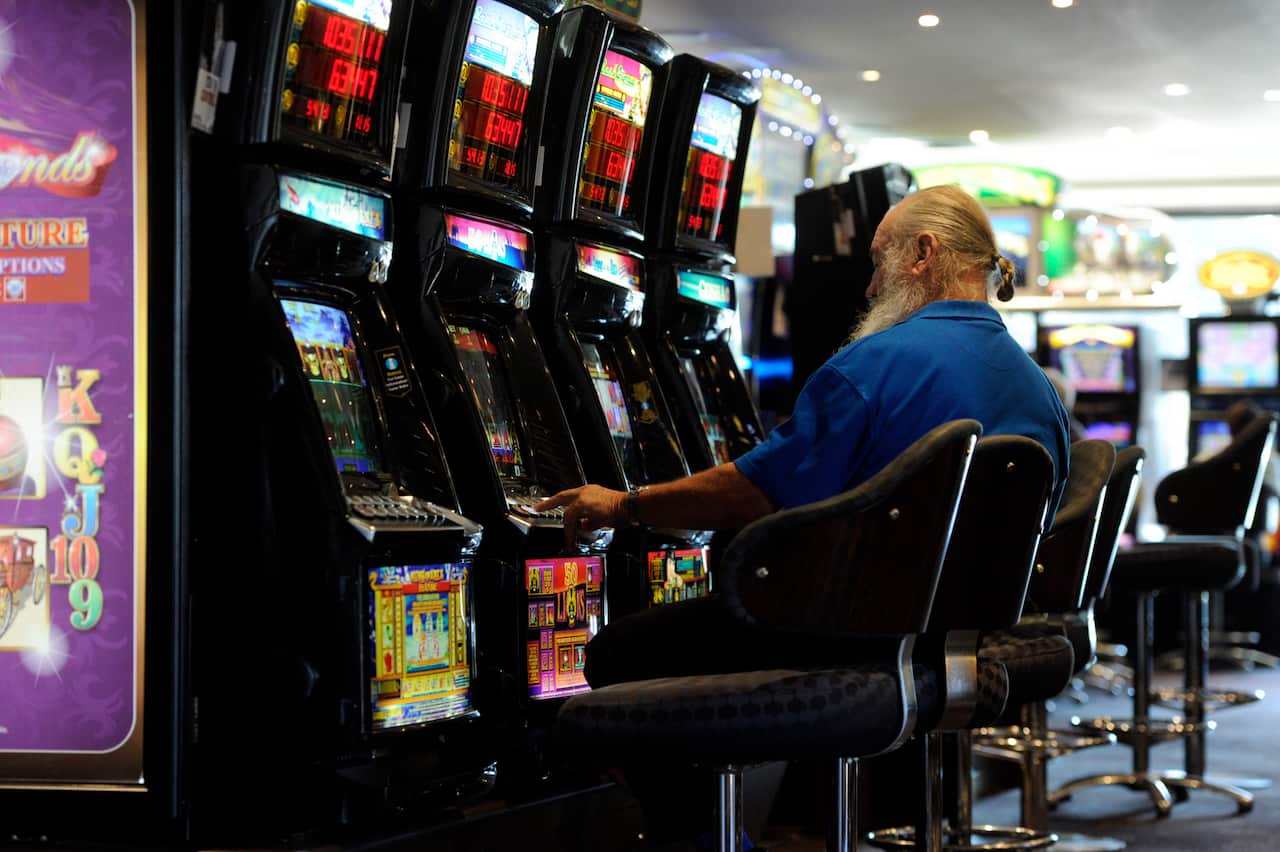 A man plays poker machines