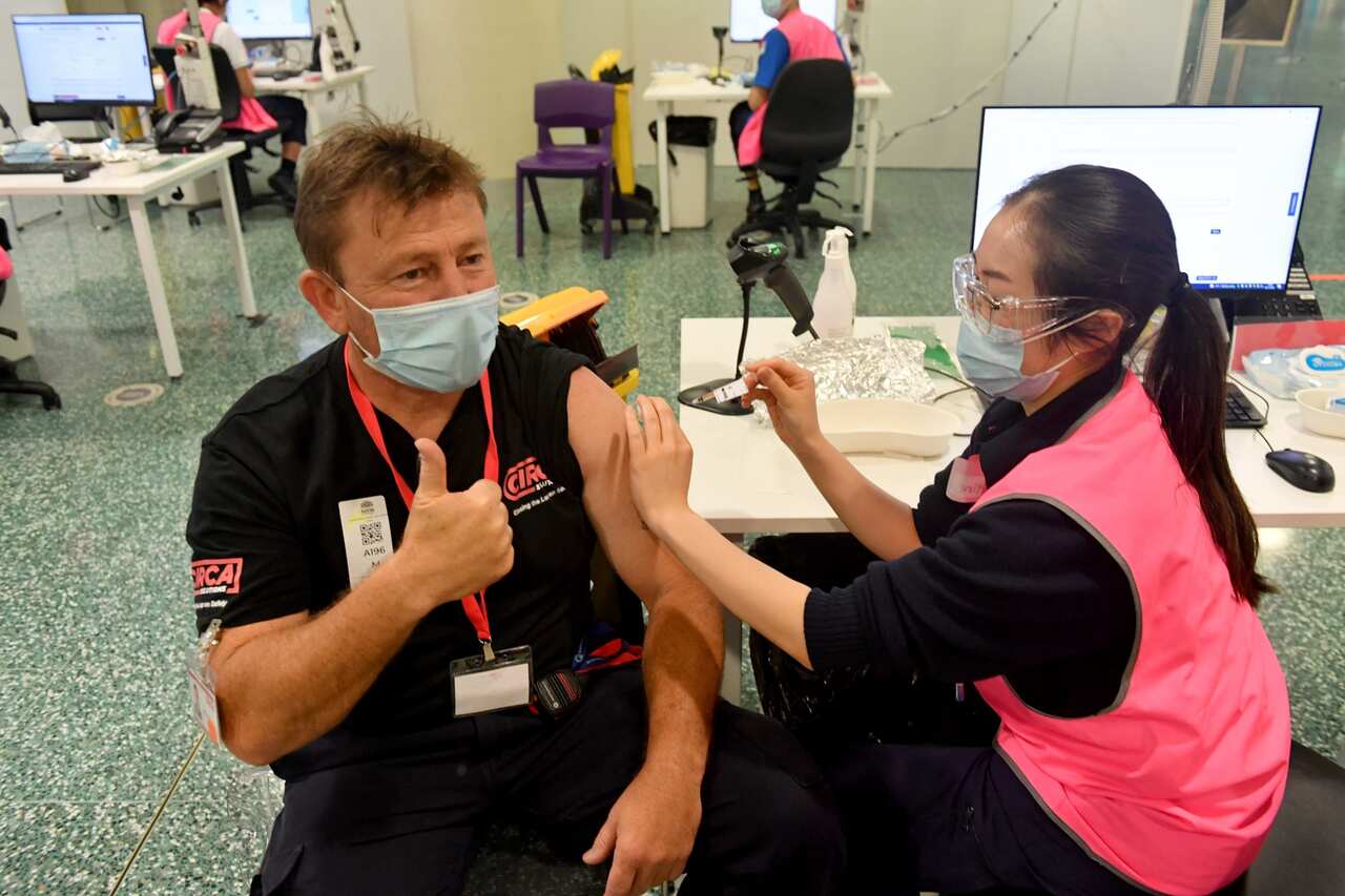 One of the last members of the public receives his booster Pfizer vaccine at Qudos Bank Arena Vaccination Centre before it close in Sydney, Sunday, November 7, 2021. (AAP Image/Mick Tsikas) NO ARCHIVING