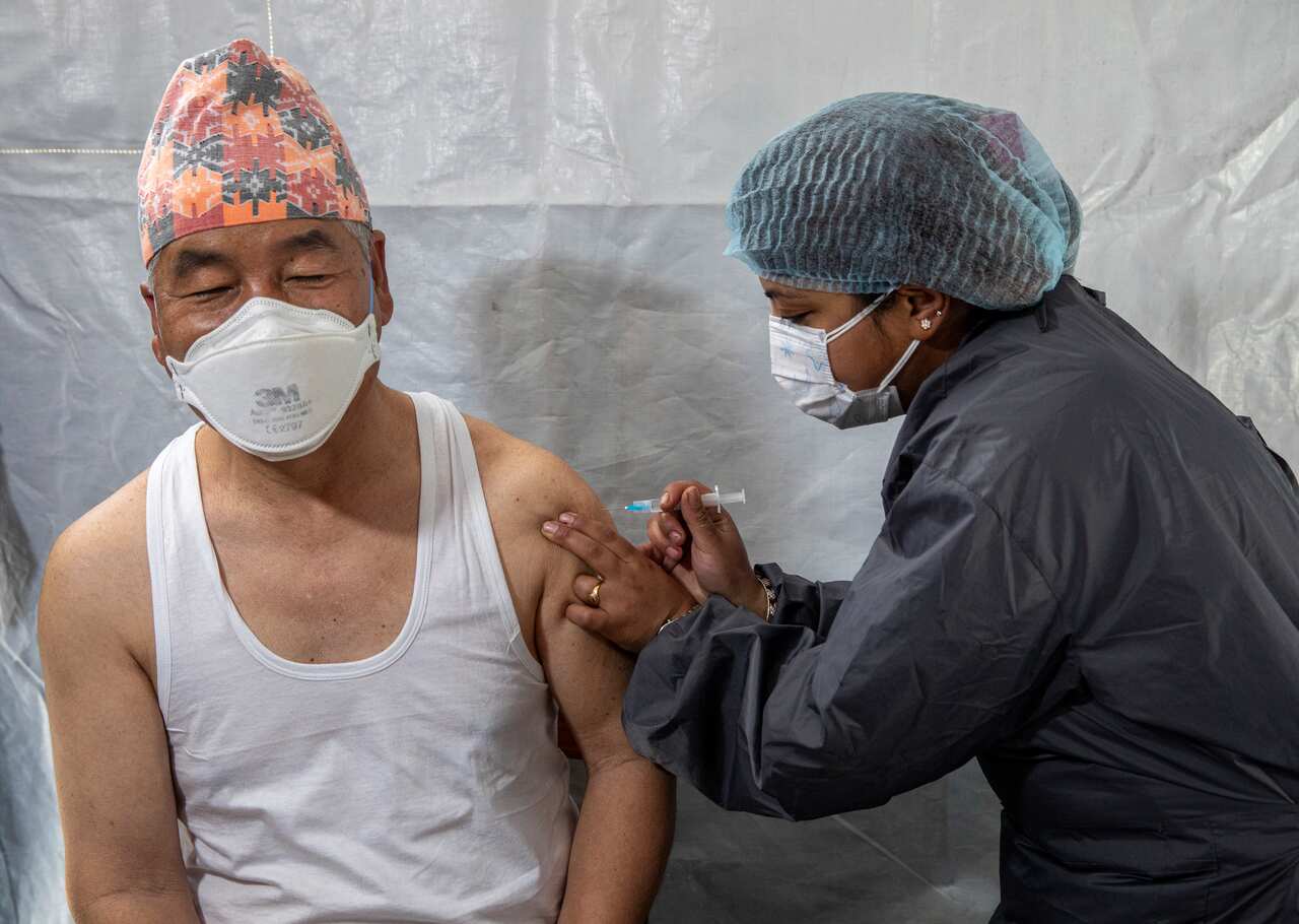 A Nepali parliamentarian (L) receives a dose of Covishield COVID-19 vaccine at Civil hospital in Kathmandu, Nepal, 03 March 2021.  EPA/NARENDRA SHRESTHA
