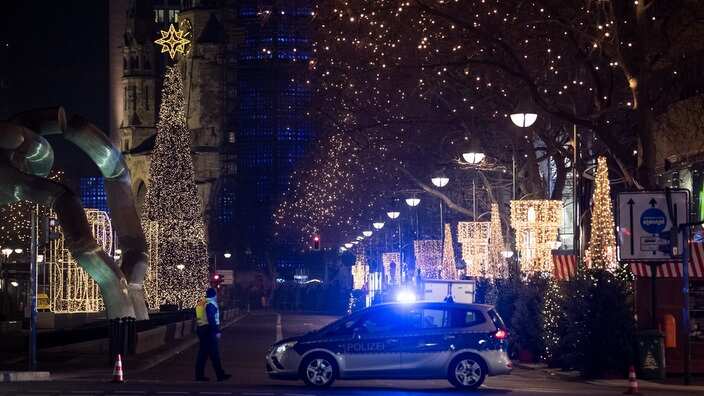 A vehicle of the police blocks the entrance to the Christmas market at Breitscheidplatz, close to the Kaiser Wilhelm Memorial Church, in Berlin