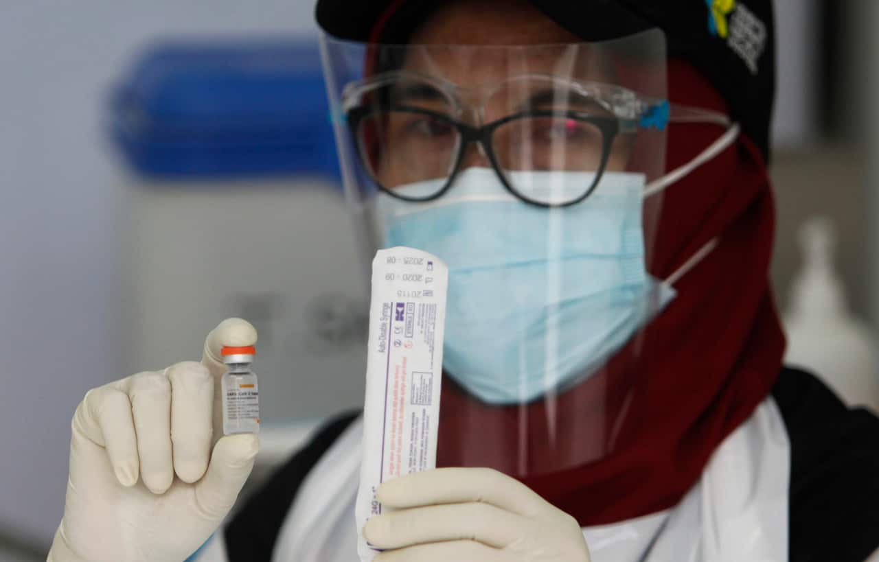 A health worker poses with a vial containing a vaccine Sinovac for the COVID-19 coronavirus at the health office in Bogor, West Java, Indonesia. 