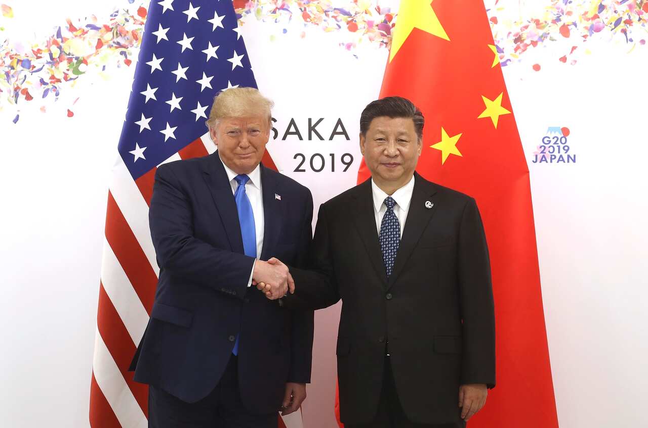 Chinese President Xi Jinping (R) shakes hands with US President Donald Trump.