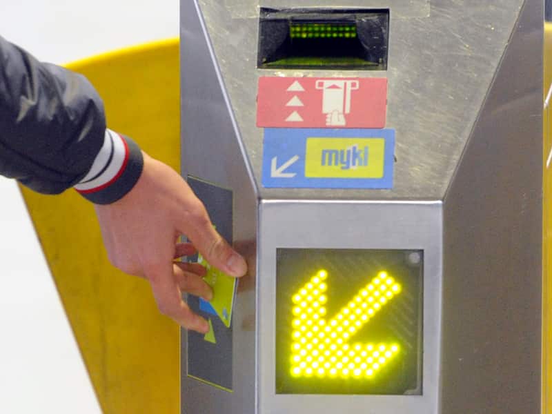 A public transport user swipes a myki card