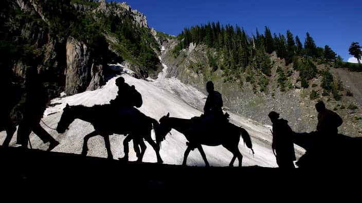 Pigrims on ponies and mules going to Amarnath