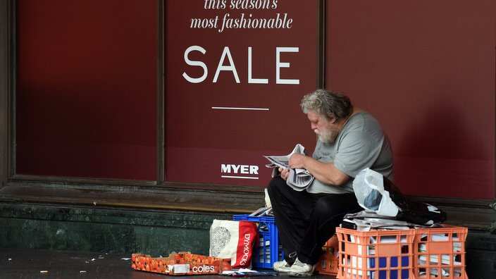 A homeless man is seen with his belongings outside the Myer department store in Sydney on Friday, March 25, 2016. (AAP Image/Mick Tsikas) NO ARCHIVING