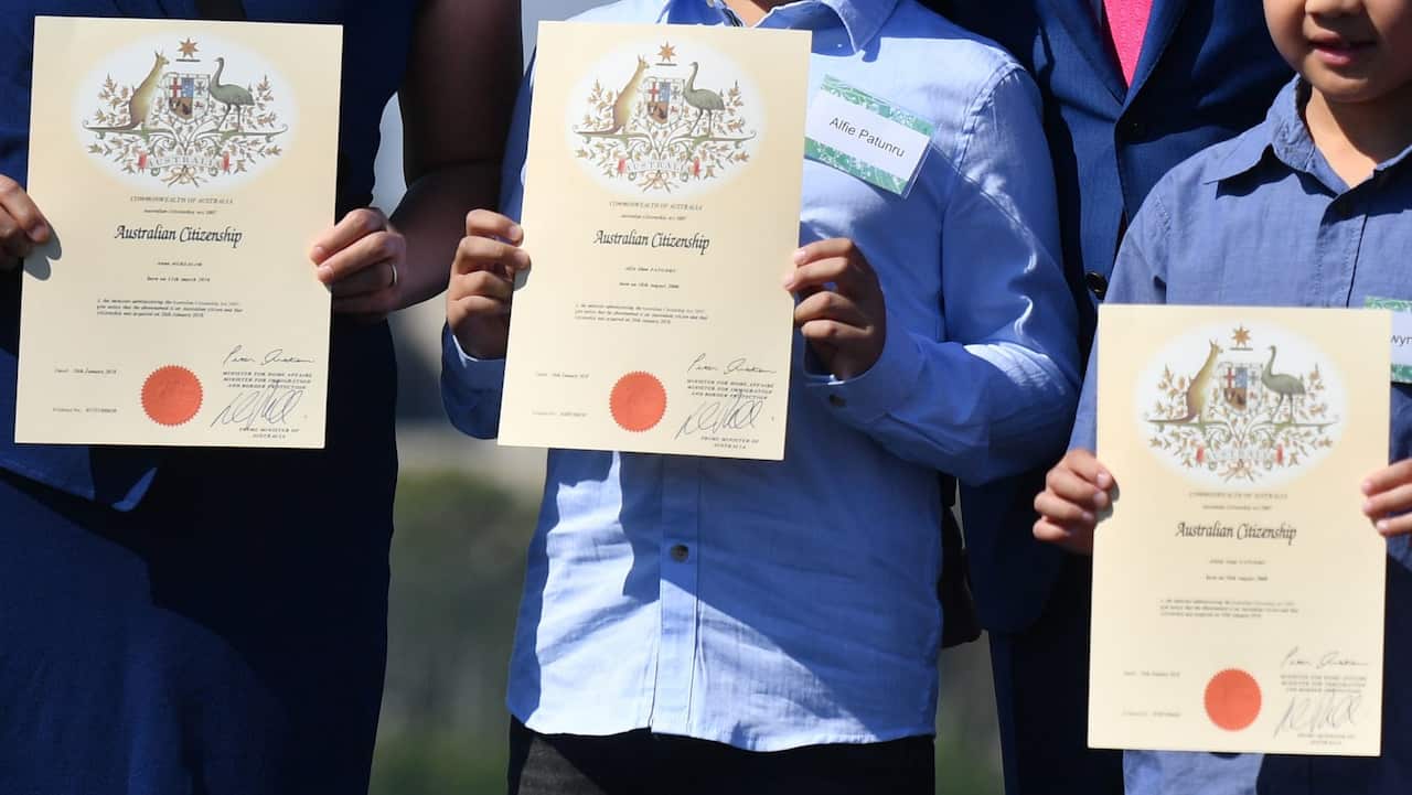 Prime Minister Malcolm Turnbull poses with new Australian citizens at an Australia Day Citizenship Ceremony and Flag Raising event in Canberra, Friday, January 26, 2018. (AAP Image/Mick Tsikas) NO ARCHIVING
