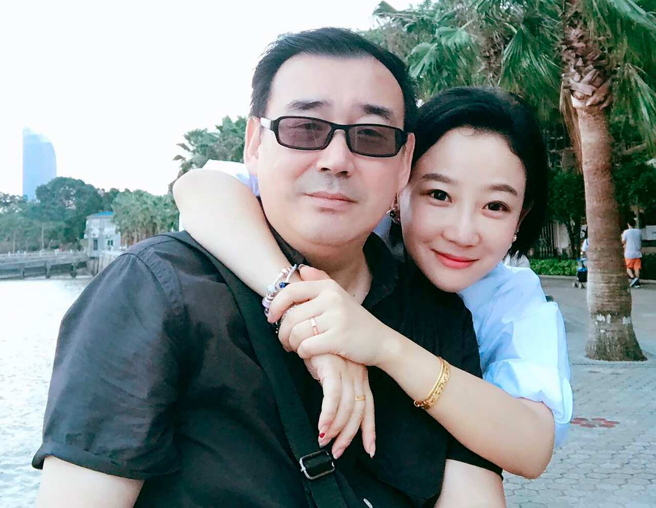 Yang Hengjun, left, poses with his family member in Beijing.
