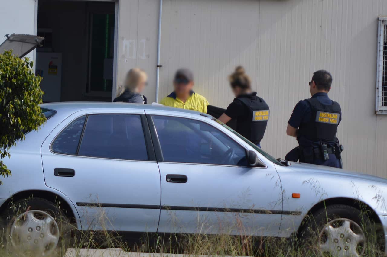 ABF officers interviewing a farm worker