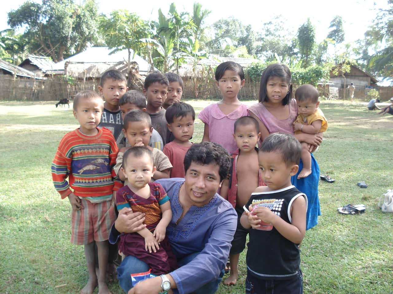 Nairwng (in her dad's lap) at the age of 16 months with her childhood friends in Bangladesh.