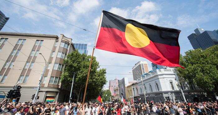 Protesters holding Aboriginal falg