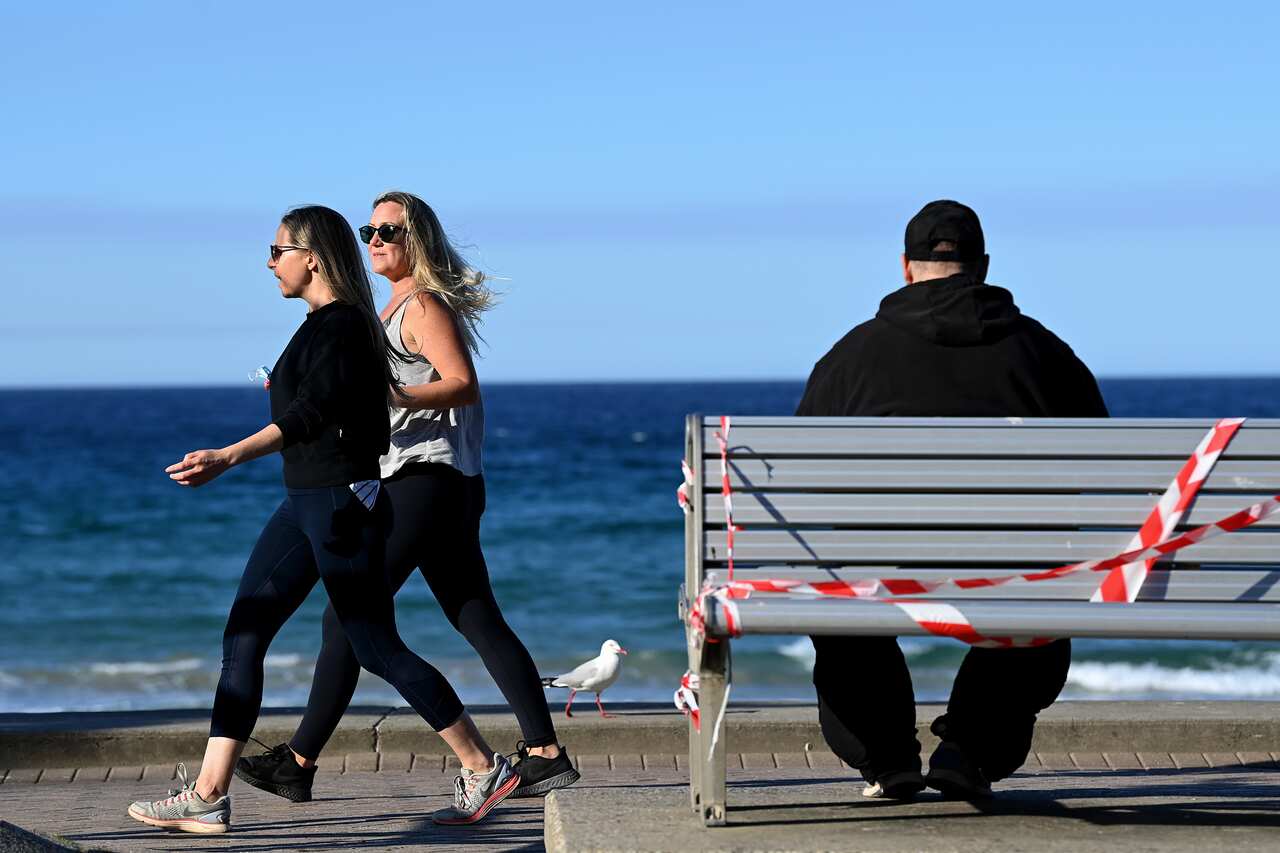 Members of the public exercise along Manly Beach in Sydney.