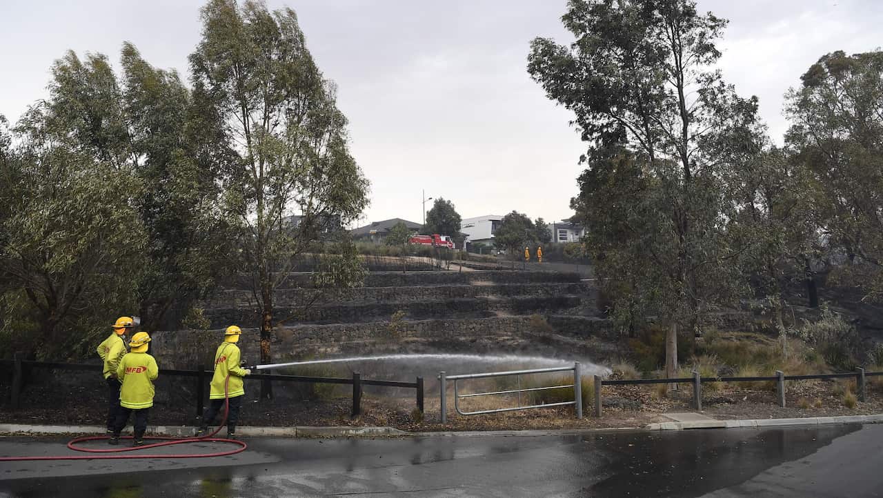 CFA firefighters are seen after a fire impacted Clovemont Way, Bundoora in Melbourne, 30 December 2019.