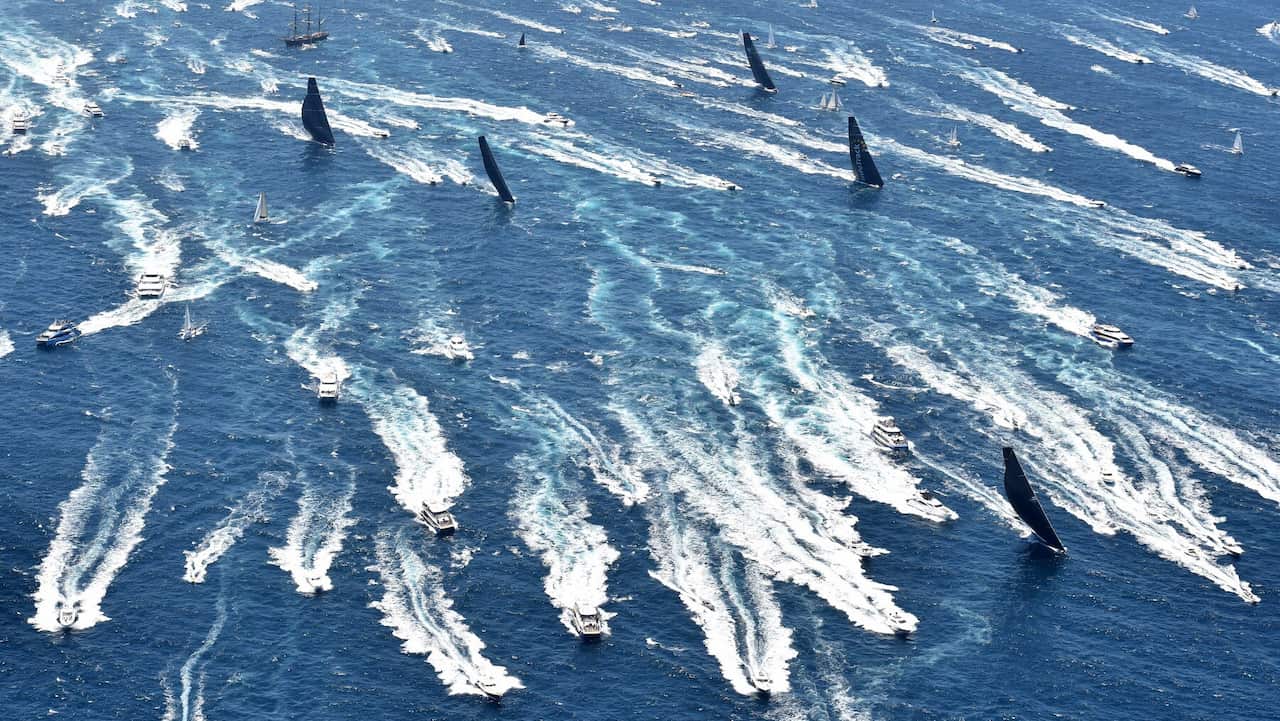 Black Jack leads the fleet through Sydney Heads during the start of the Sydney to Hobart Yacht 2018 race.