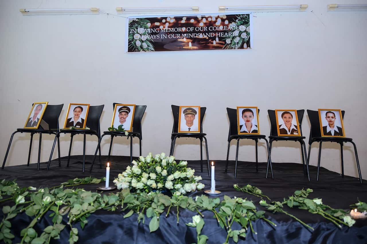 Photographs of the crew members of the Ethiopian Airlines flight ET 302 that crashed are displayed during a memorial service.