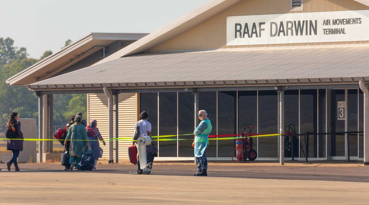 Passengers disembark a Qantas repatriation flight from India at RAAF Base Darwin.
