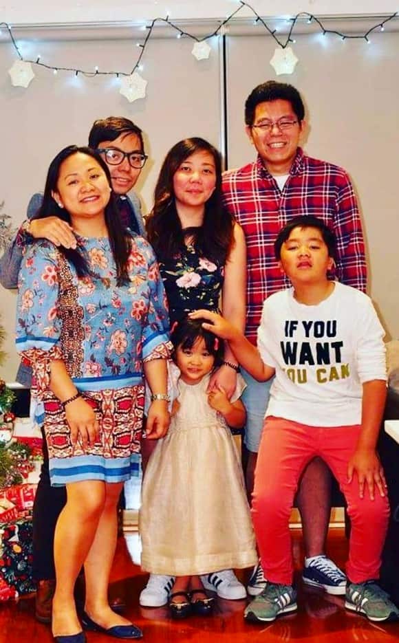 Joan ANgelina Mercader with Filipino migrants she welcomed in her home