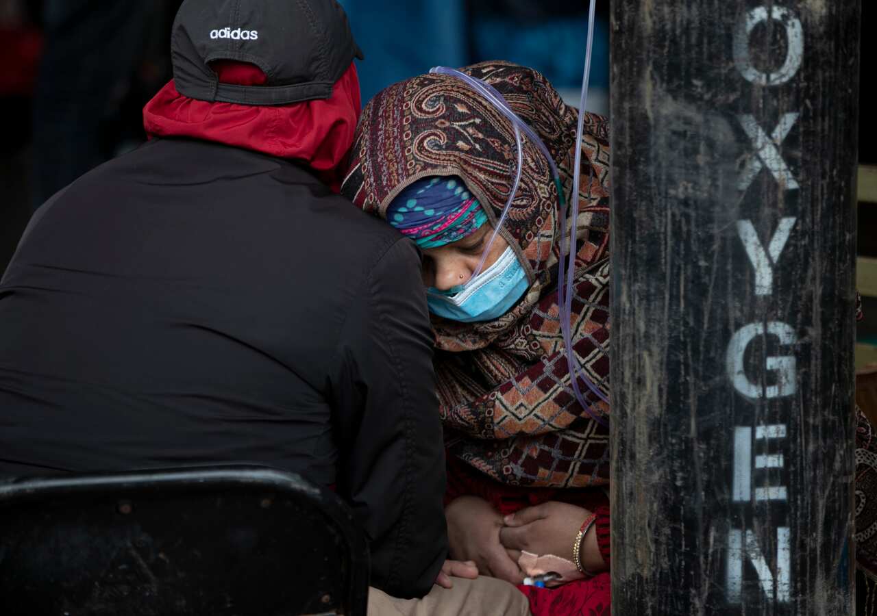 A COVID-19 patient receives oxygen outside an emergency ward at a government-run hospital in Kathmandu, Nepal on Thursday, 13May, 2021.