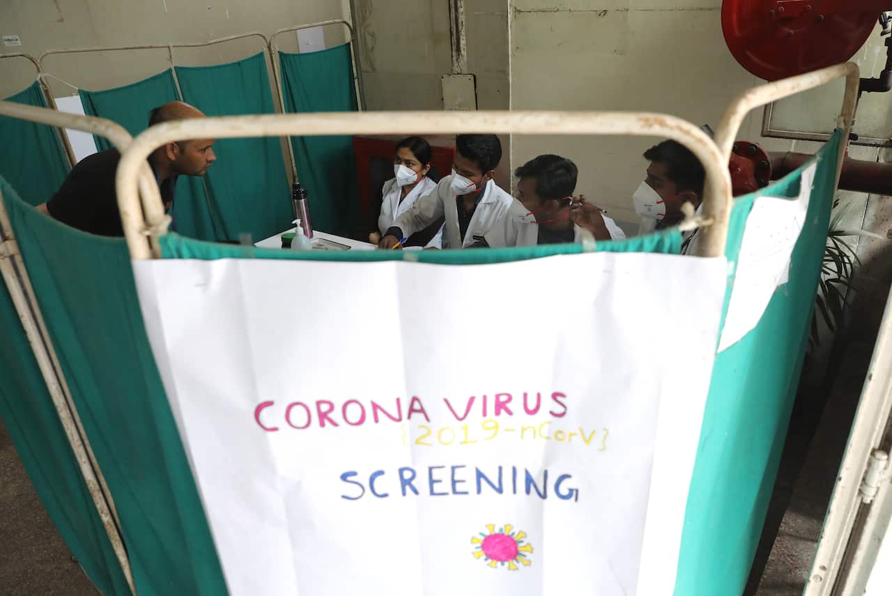Indian doctors screen patients for Coronavirus at Nehru Homoeopathic Medical College and Hospital in New Delhi, India, March 2020.