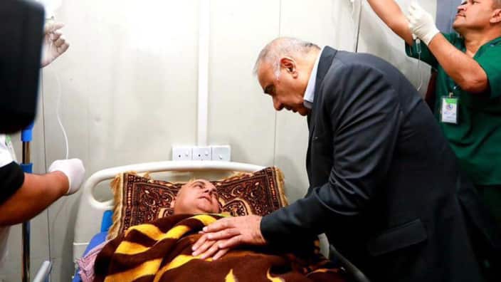 Iraqi Prime Minister Adel Abdel Mahdi (C) visiting the people who survived the overloaded ferry that sank in the Tigris river