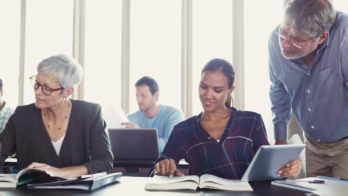 Students studying in adult education classroom