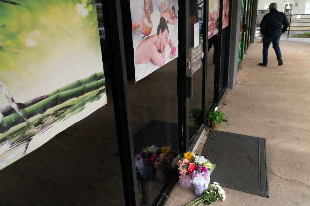 Flowers are seen outside a massage parloir where four people were shot and killed on 17 March 2021 in Acworth, Georgia.