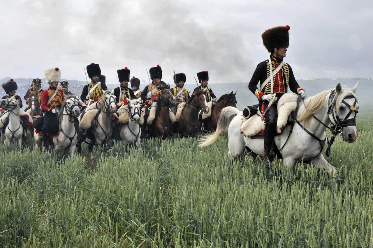 People dressed up as soldiers fight during a re-enactment of the 1815 Battle of Waterloo between the French army led by Napoleon and the Allied armies (AAP)