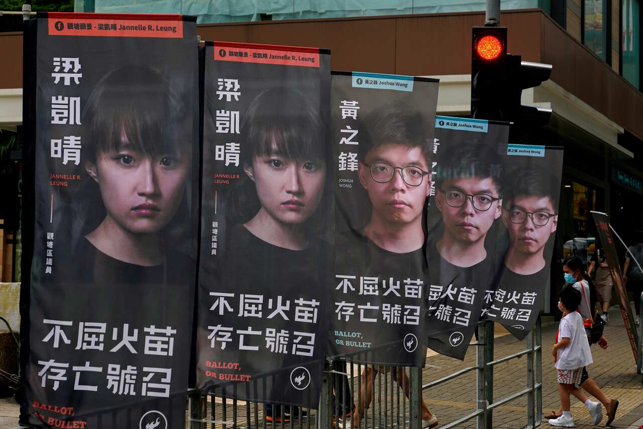 Banners of a pro-democracy candidate Joshua Wong outside a subway station in Hong Kong last July, in an unofficial "primary" ahead of legislative elections.