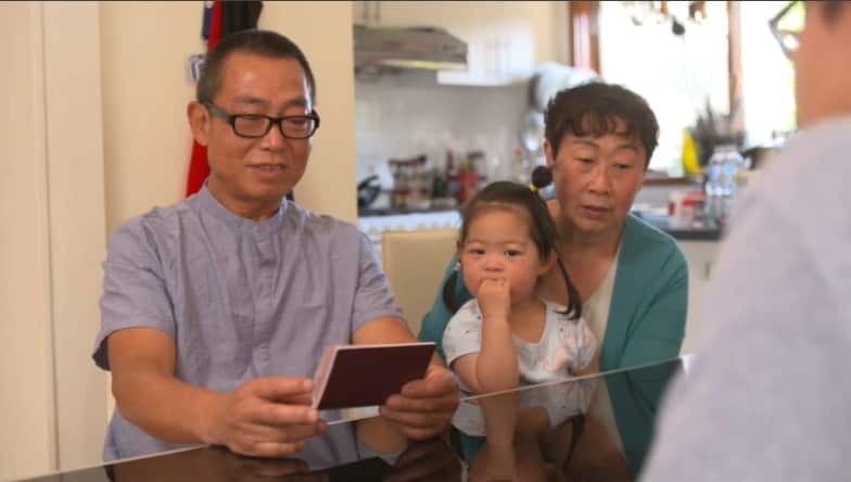 Grandparents Dong Liu and Lixia Wang with their granddaughter.