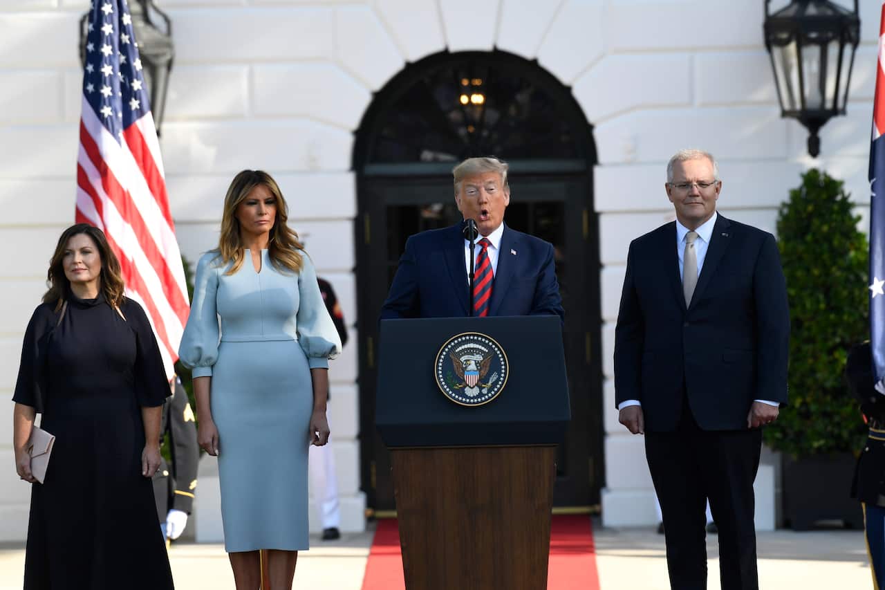 President Donald Trump speaks as Scott Morrison, Jenny Morrison (left) and Melania Trump listen.