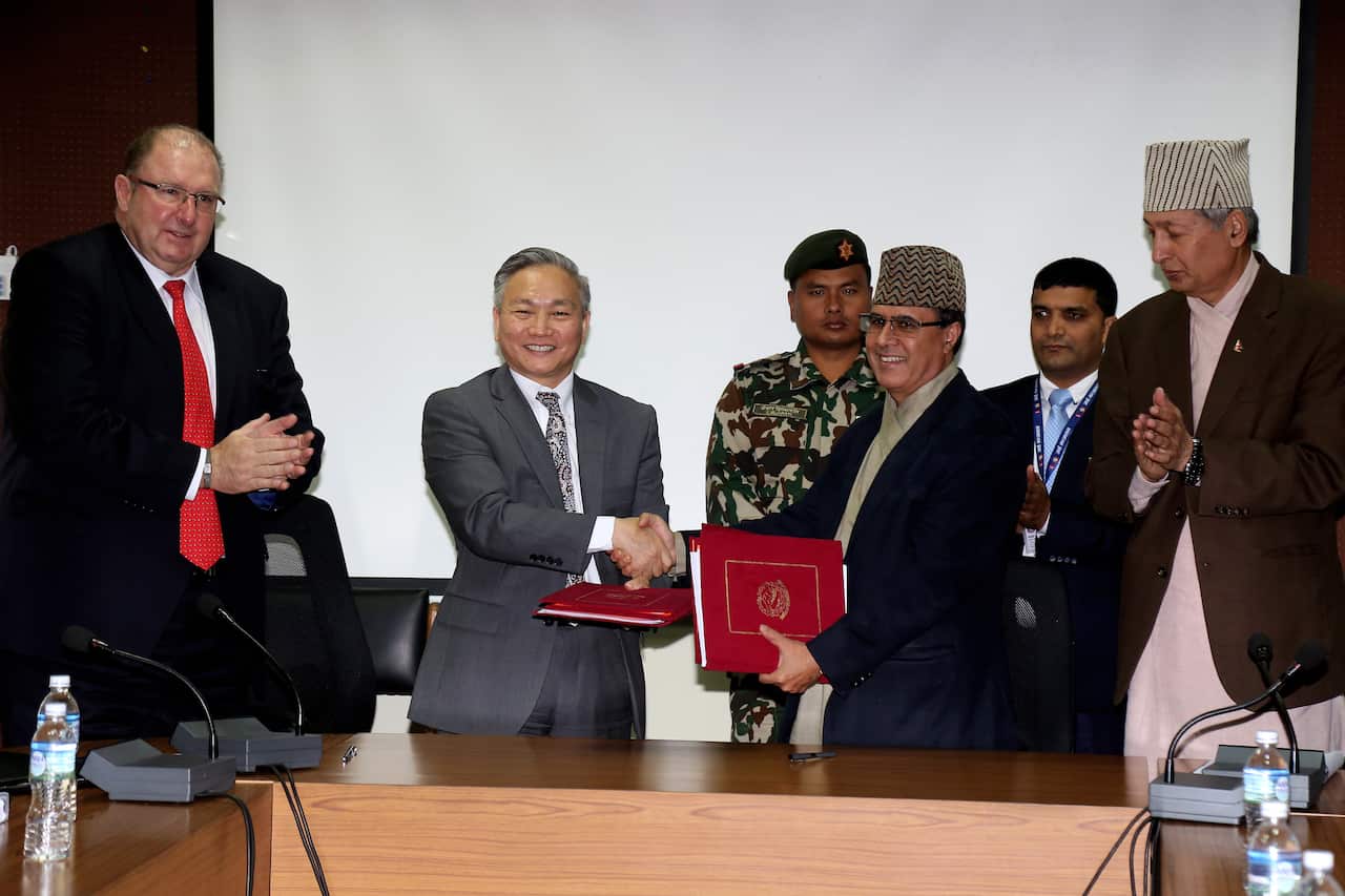 Nepal Government and the World Bank signing an agreement to improve infrastructure and food projects.
