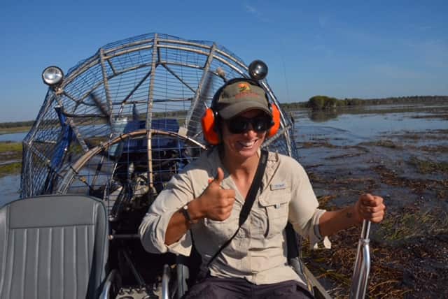 Anna Teneggi driving an airboat.
