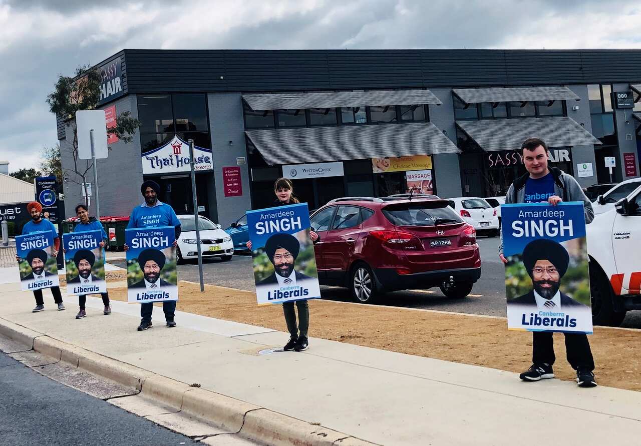 Supporters with posters during the election campaign in Canberra