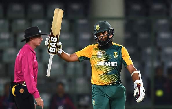 South Africa's Hashim Amla (R) raises his bat after his half century during the World T20 cricket tournament match between South Africa and Sri Lanka