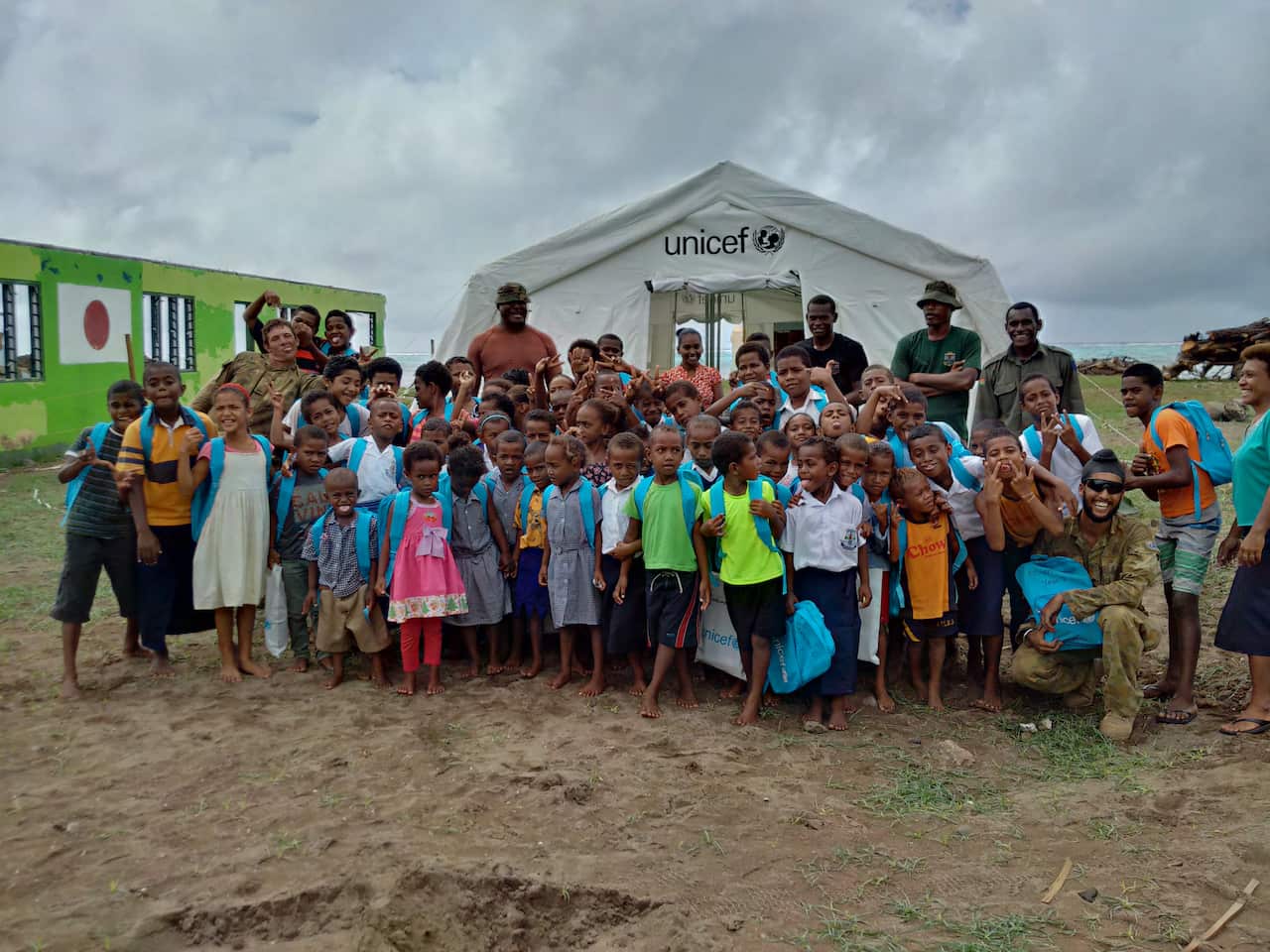 A photo taken during Operation Fiji Assist, alongside the local community that received help from Australian troops