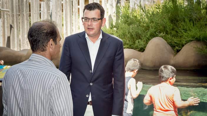 Premier Daniel Andrews with a family seeking asylum
