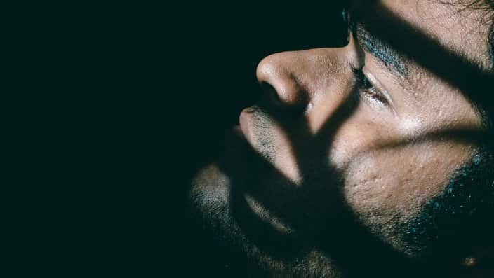 Close-Up Of Man Over Black Background